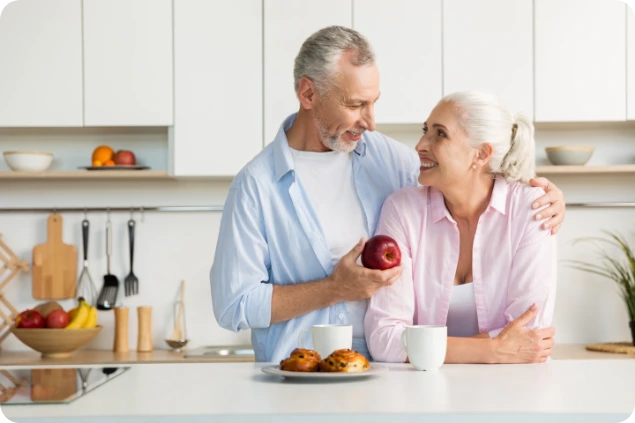 Pareja de adultos compartiendo una manzana.
